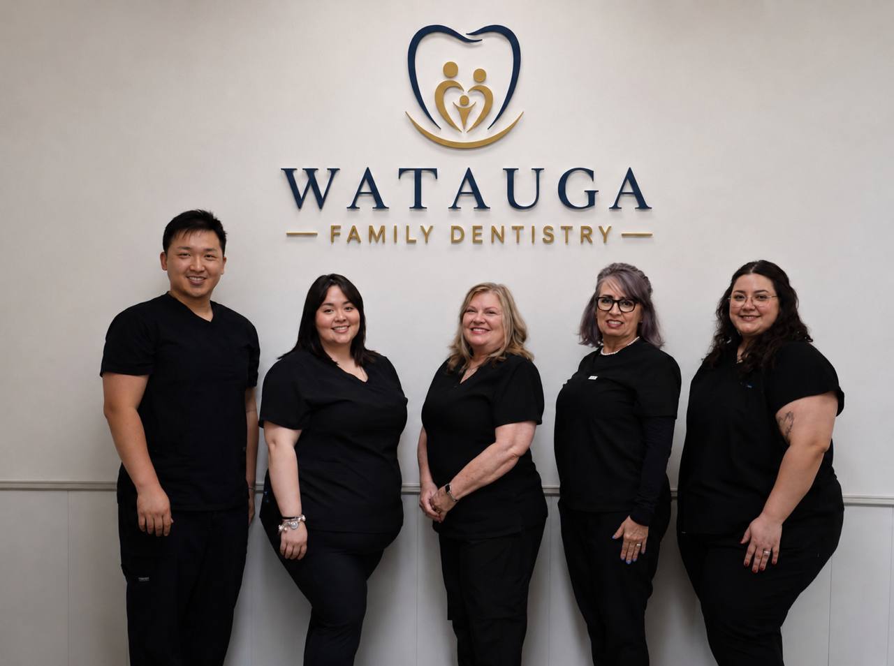 The Watauga Family Dentistry team in front of our logo